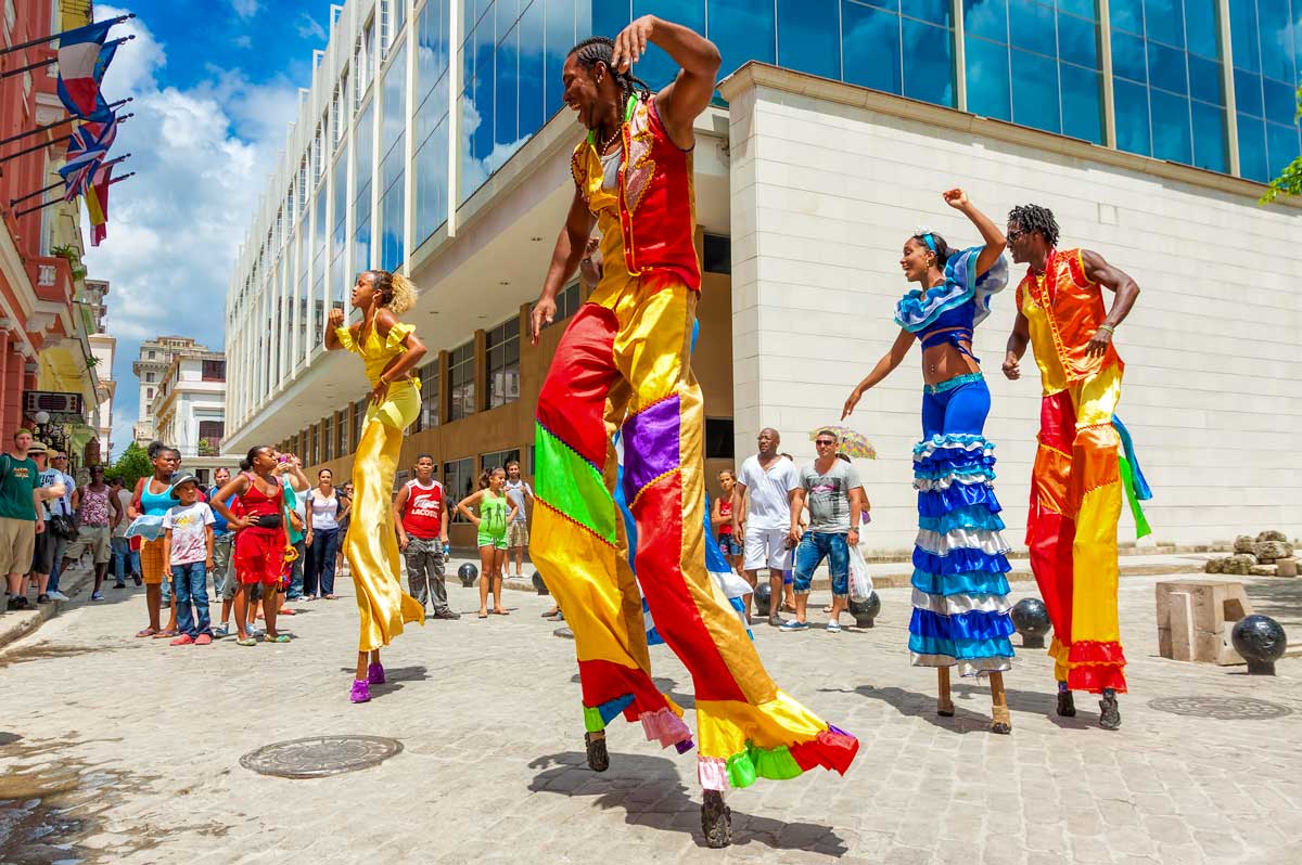 performers in colorful costumes walking on stilts