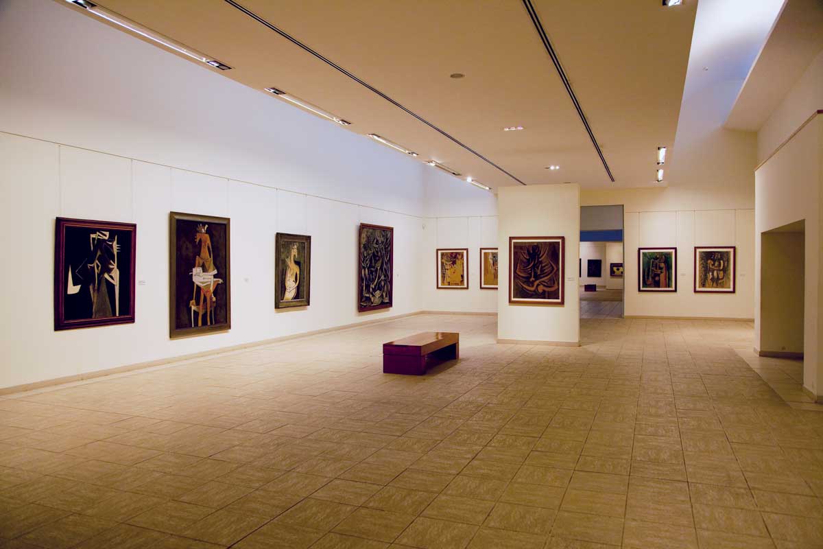 exhibition area at art museum with paintings on walls
