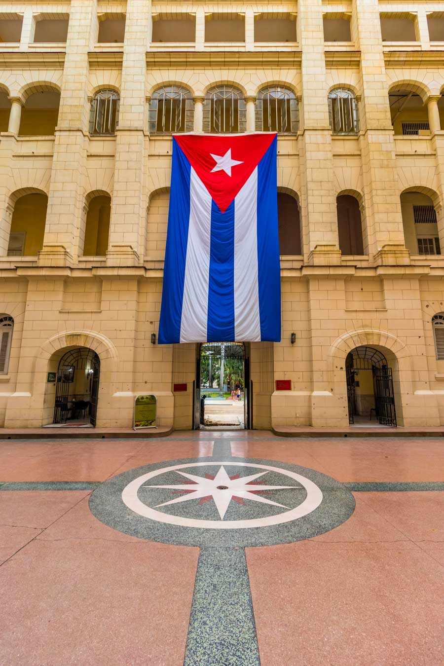 large cuban flag inside a building courtyard