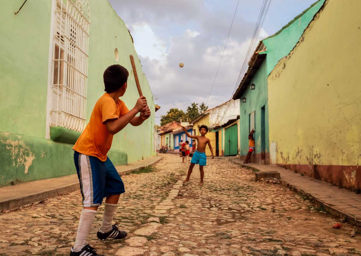 Cuban boys playing baseball in Trinidad – Photo: Shutterstock